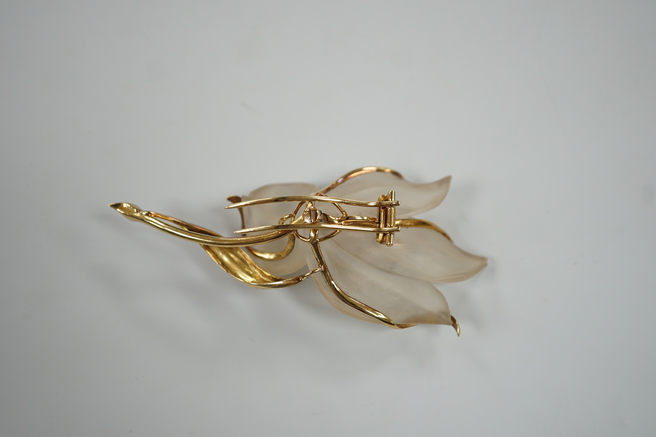 A modern continental yellow metal, sapphire and diamond set frosted glass? flower clip brooch, 85mm, gross 25.8 grams.